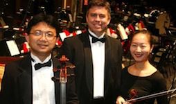 Members of the Archduke Trio posing for a picture on the Mobile Saenger Theatre stage.