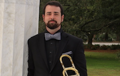 Pictured at the Greek columns on the USA campus is senior trombonist Brandon Bodie.