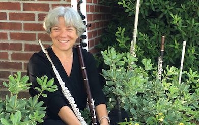 Pictured sitting in a garden with several types of flutes is Dr. Andra Bohnet.