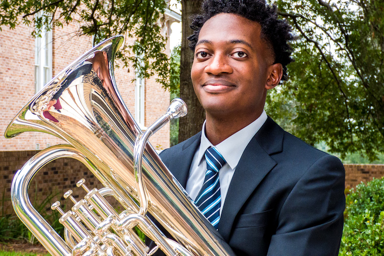 Rodney Byrd standing outside in courtyard with instrument ready for Senior Euphonium Recital at Laidlaw