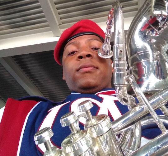 closeup of Kenneth Coleman in his band uniform holding his tuba