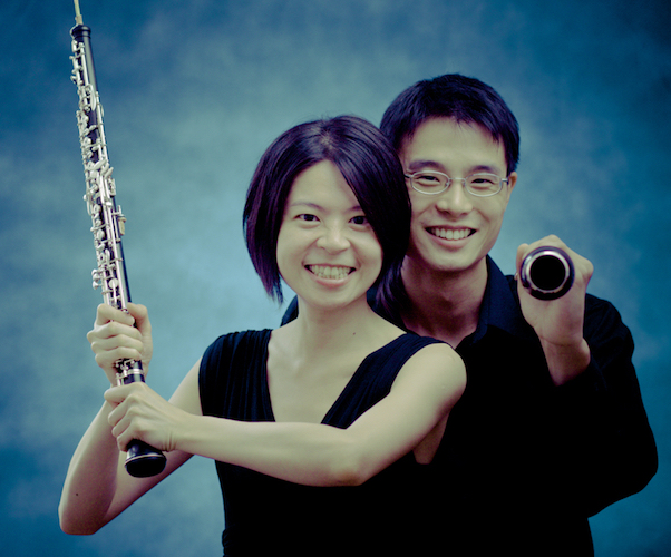 Oboe Duo Agosto, Ling-Fei Kang and Charles Huang each holding their instrument