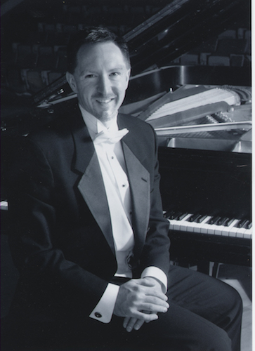 black and white of Dr. James Helton seated at piano