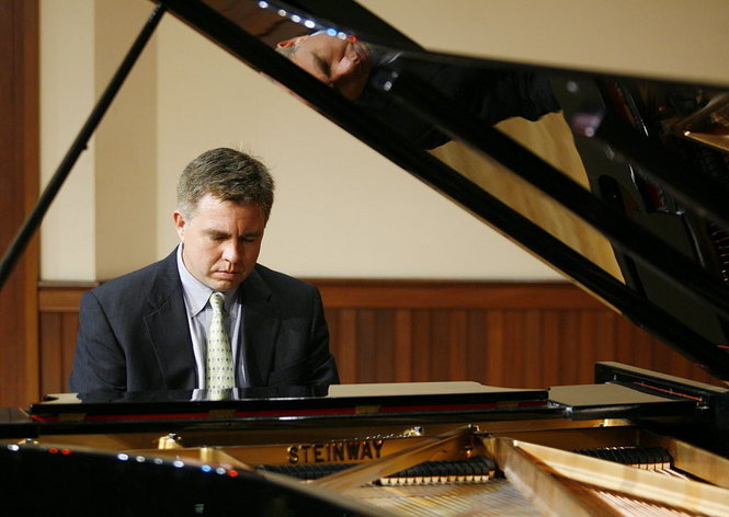Robert Holm pictured at the piano on stage.