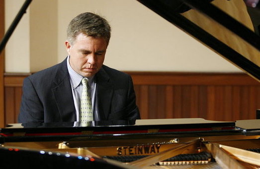 Pictured playing the Steinway piano is Dr. Robert Holm.