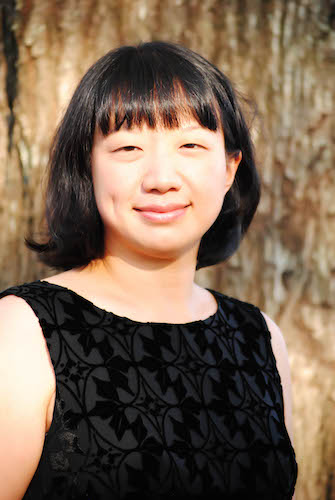 Dr. Sharon Hudson standing beside a tree