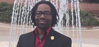 Pictured standing by the Laidlaw Performing Arts Center fountain is trumpeter Jaleel Hughes.