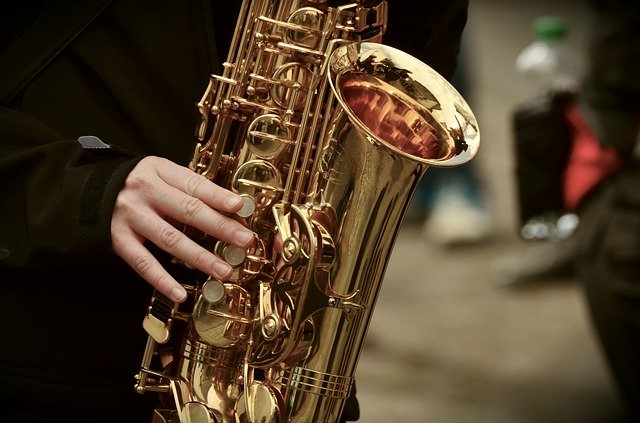 Pictured is a saxophonist playing and alto sax. data-lightbox='featured'