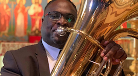 Pictured playing the tuba is USA faculty tubist Dr. Clayton Maddox.