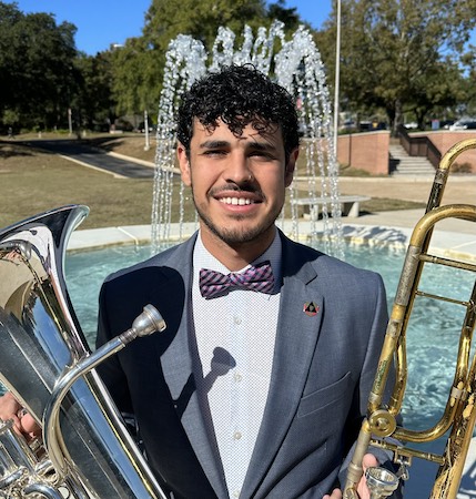 Pictured holding both the trombone and euphonium is senior low brass performer Juan Carlos Mata. data-lightbox='featured'