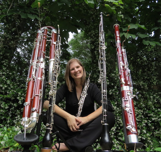 Picture in a garden both green and full of double-reed instruments is USA Faculty Dr. Rebecca Mindock. data-lightbox='featured'