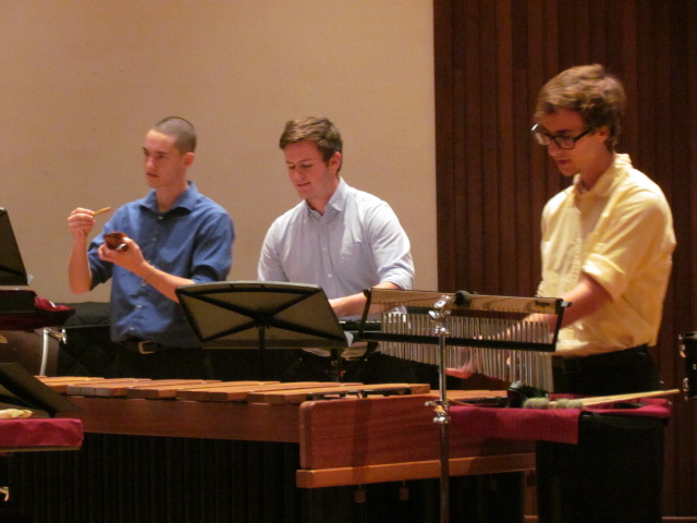 three members of USA Percussion Ensemble performing on stage