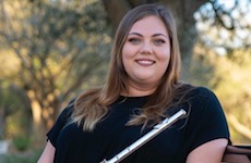 Pictured on an outdoor bench holding her flute is graduate student Rebecca Reinhardt.
