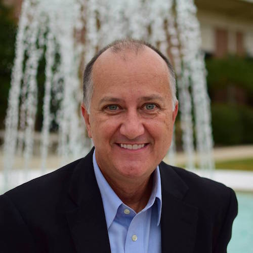 Thomas L. Rowell standing with Laidlaw fountain in the background