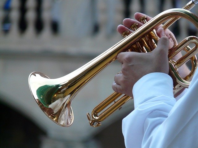 Pictured is a flugelhorn being played anonymously. data-lightbox='featured'