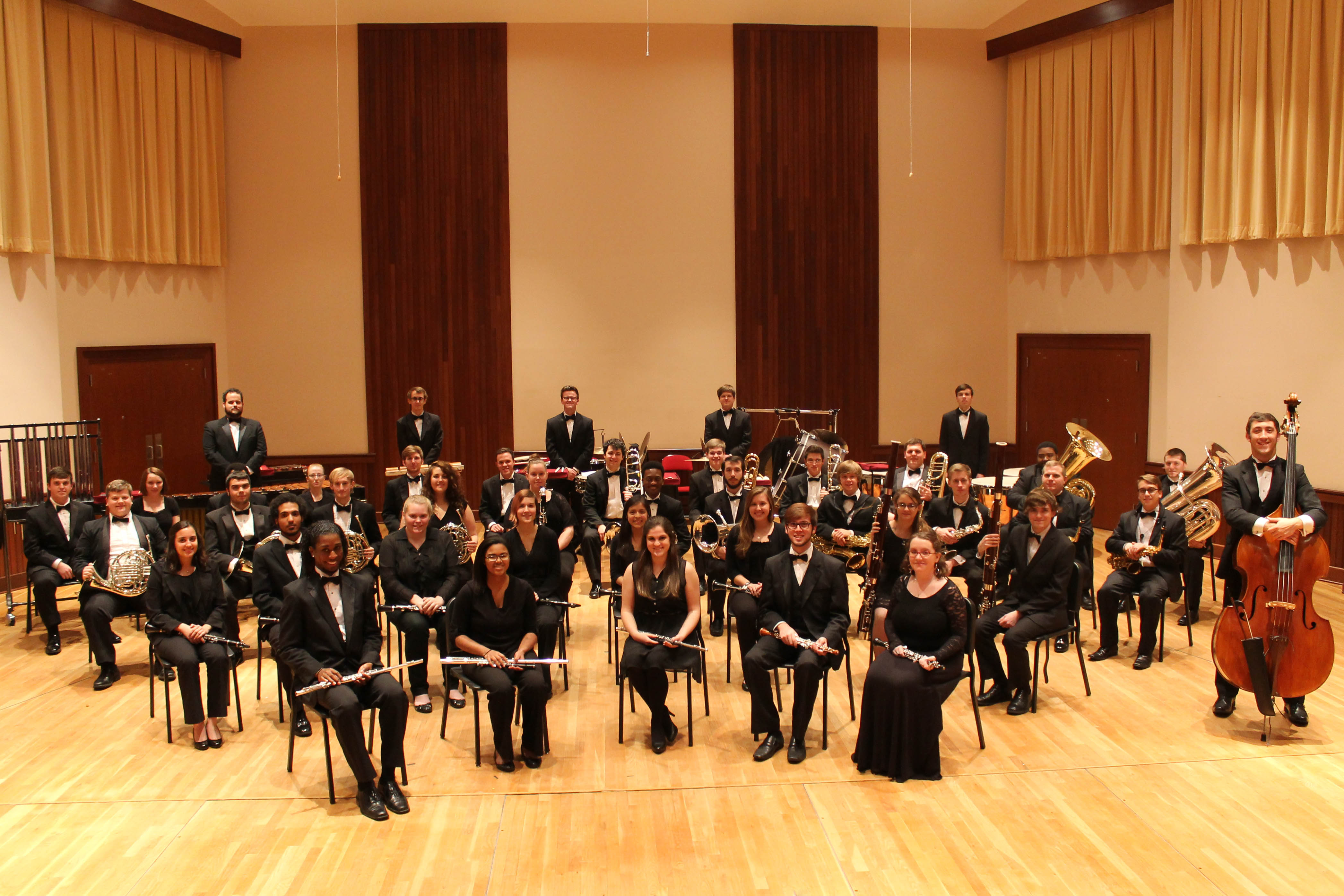 members of USA Wind Ensemble and Symphony Band on stage in before performance