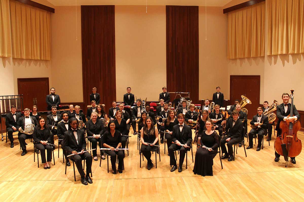 members of USA Wind Ensemble and Symphony Band on stage in before performance