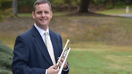 Pictured outside the Laidlaw Performing Arts Center holding one of his many trumpets is USA Faculty Dr. Peter Wood.