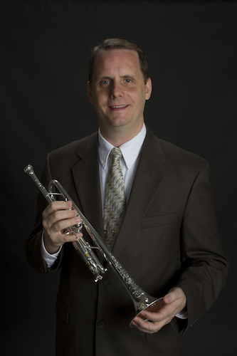 Dr. Peter Wood holding his trumpet