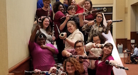 Members of the USA Woodwind Ensembles pose on the MainStage Theatre steps in the Laidlaw Performing Arts Center Lobby.