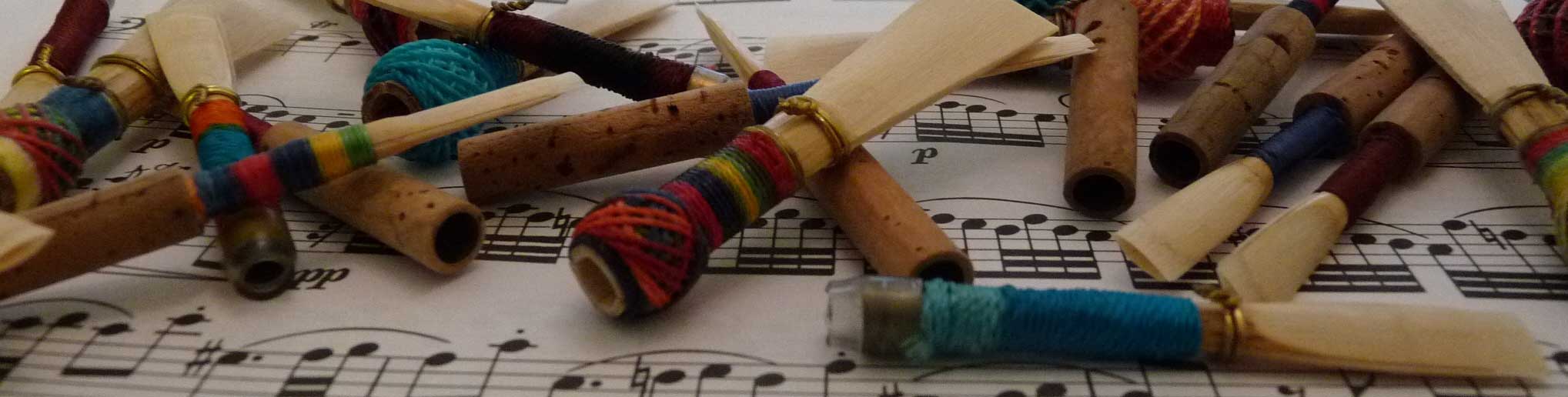 Double reeds laying on sheet music.