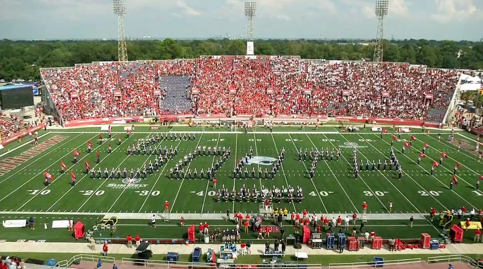 Band spelling out South on the football field at game.