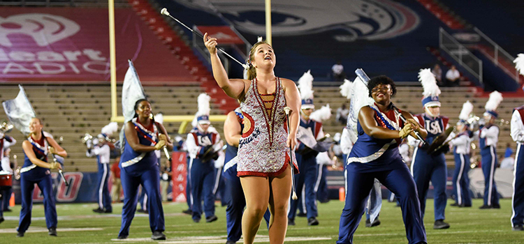 band performing with featured twirler