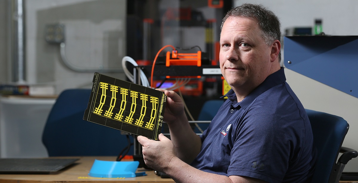 Ricky Green, an information technology instructor at the University of South Alabama, uses 3D printers to produce parts that will be put together to make face shields for healthcare workers. data-lightbox='featured'