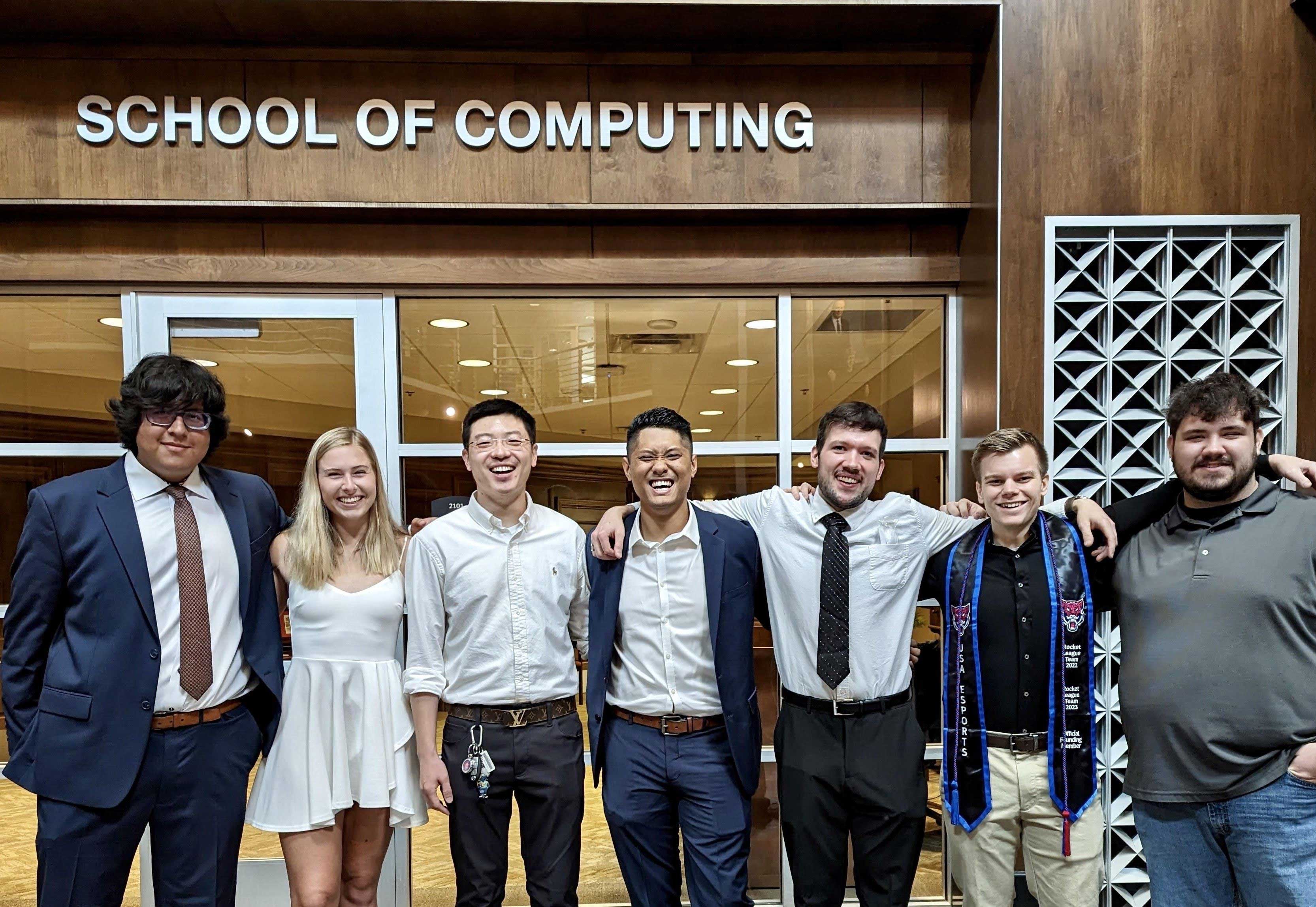 Students standing in front of the School of Computing Office 