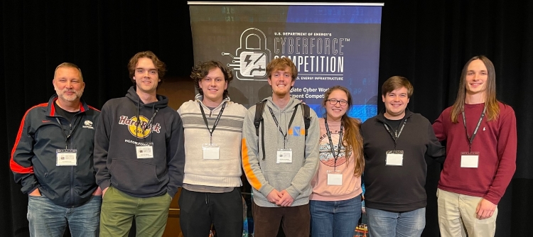CyberForce Team Members (L to R): Dr. Todd McDonald (DayZero Advisor), Zach Van Welzen, Ethan Blum, Matt Van Welzen, Rebecca Clark, Destin Hinkel, Sam Smith data-lightbox='featured'