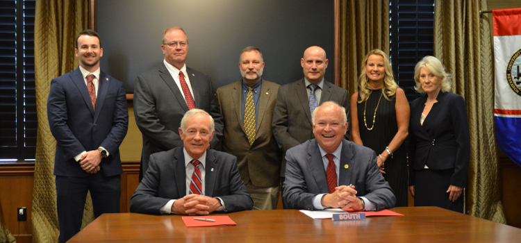 Pictured at the EPA signing ceremony (front to back, l to r) are:  Mr. Richard De Fatta (SMDC Deputy to the Commander), Mr. Jo Bonner (USA President), Mr. Chase Golden (SMDC Cyber Strategist), Mr. Terry Carlson (SMDC Chief Cyber Strategist), Dr. Todd McDonald (CFITS Director), Dr. Todd Andel (Dean, School of Computing), Dr. Andi Kent (USA Executive Vice President and Provost), Ms. Lynne Chronister (USA Vice President for Research and Economic Development)