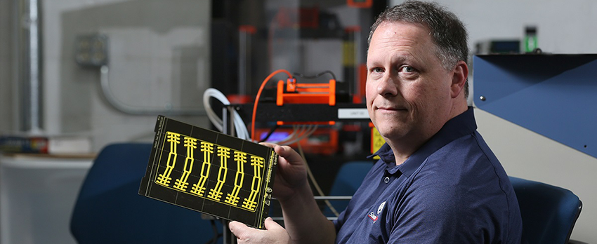 Ricky Green, an information technology instructor at the University of South Alabama, uses 3D printers to produce parts that will be put together to make face shields for healthcare workers.