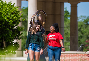 Two students walking outside of Moulton Tower.