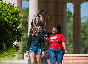 Two students walking in front of Moulton Tower.
