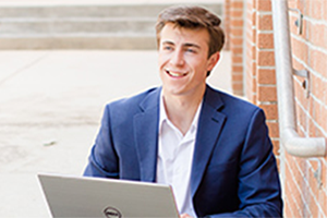 Student smiling with laptop