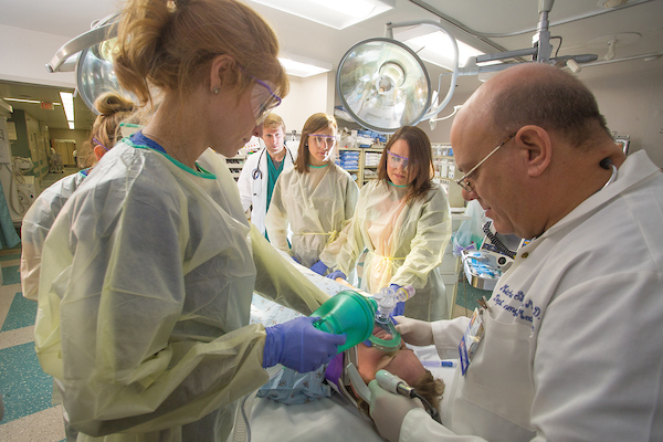 Doctor working with nurses in surgery on patient.