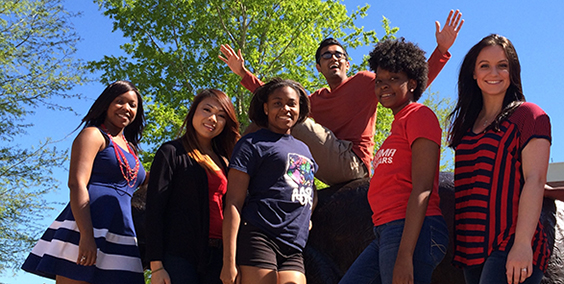 a group of students smiling outside