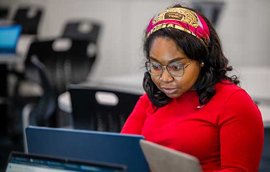 Student working on laptop.