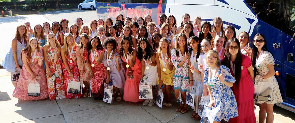 Distinguished Young Women Contestants in front of Jag bus.