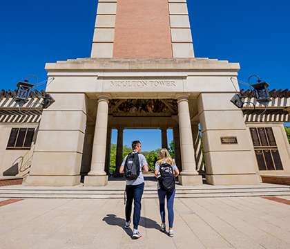 Two students walking to Moulton Tower.