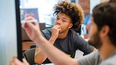 A male South student getting academic help in the Advising Center