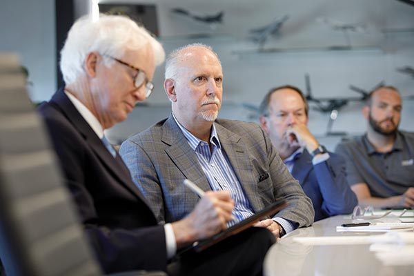 Men at table at Airbus.