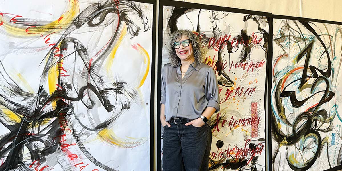 Alma Hoffman in front of art work.