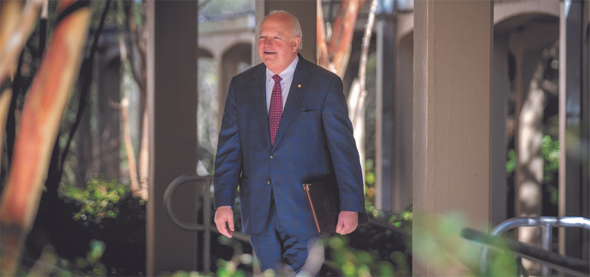 President Jo Bonner walking across campus.