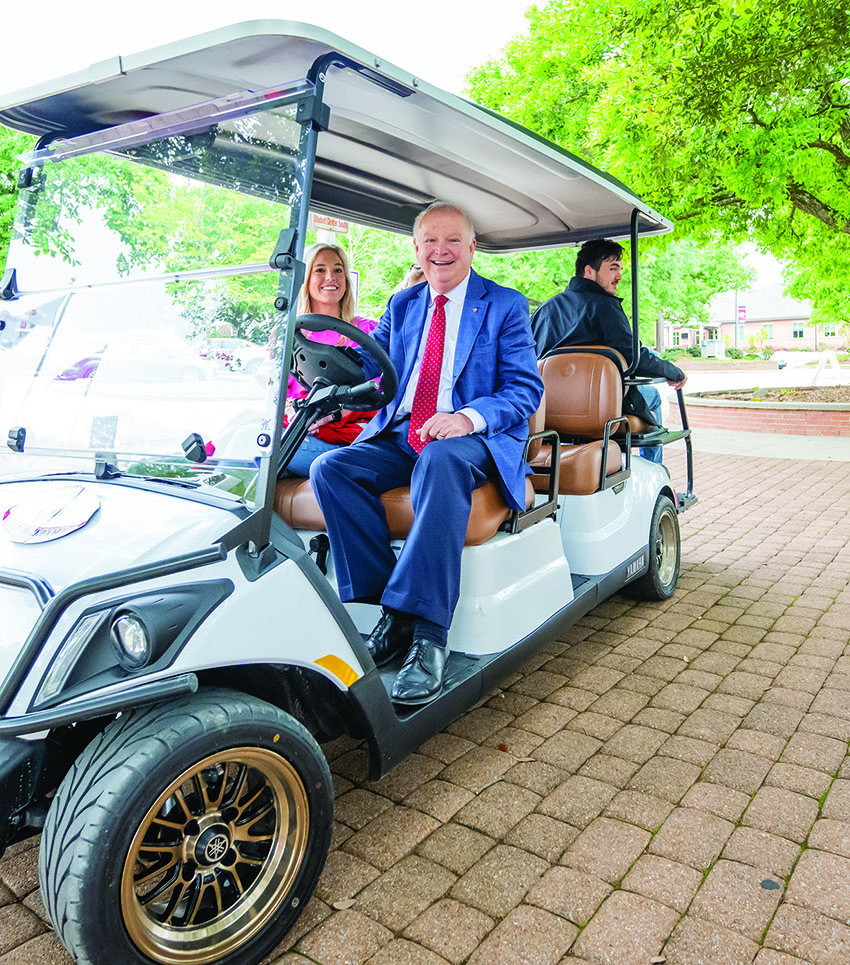 President Bonner on golfcart.
