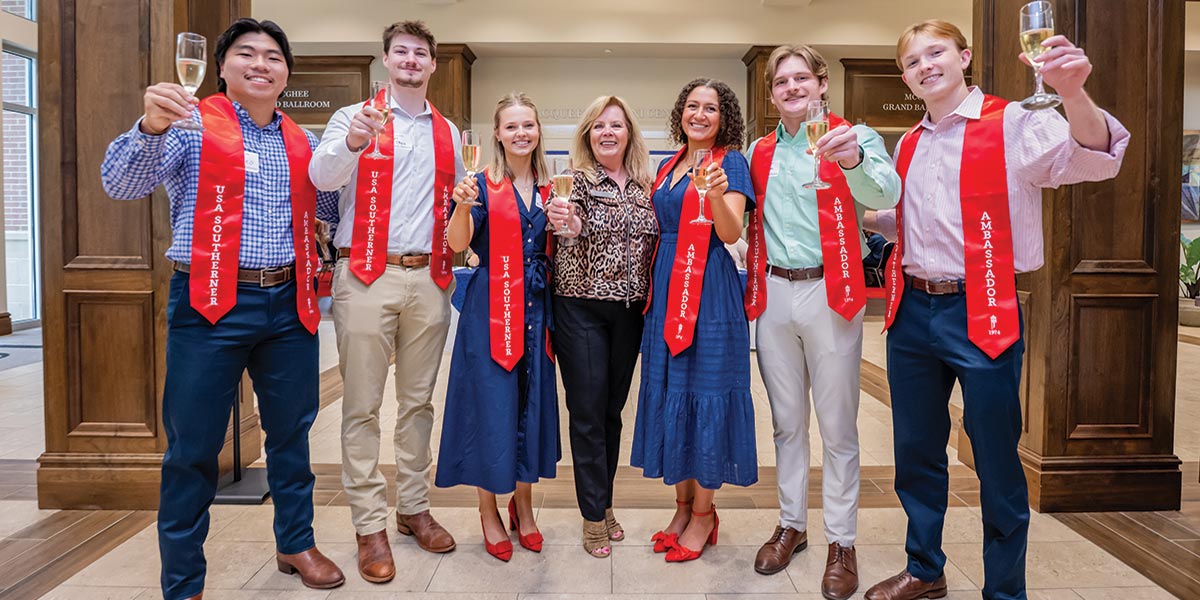 Champagne toast of graduates at Alumni Center