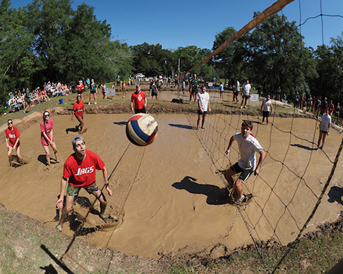 Student playing oozeball in the mud.