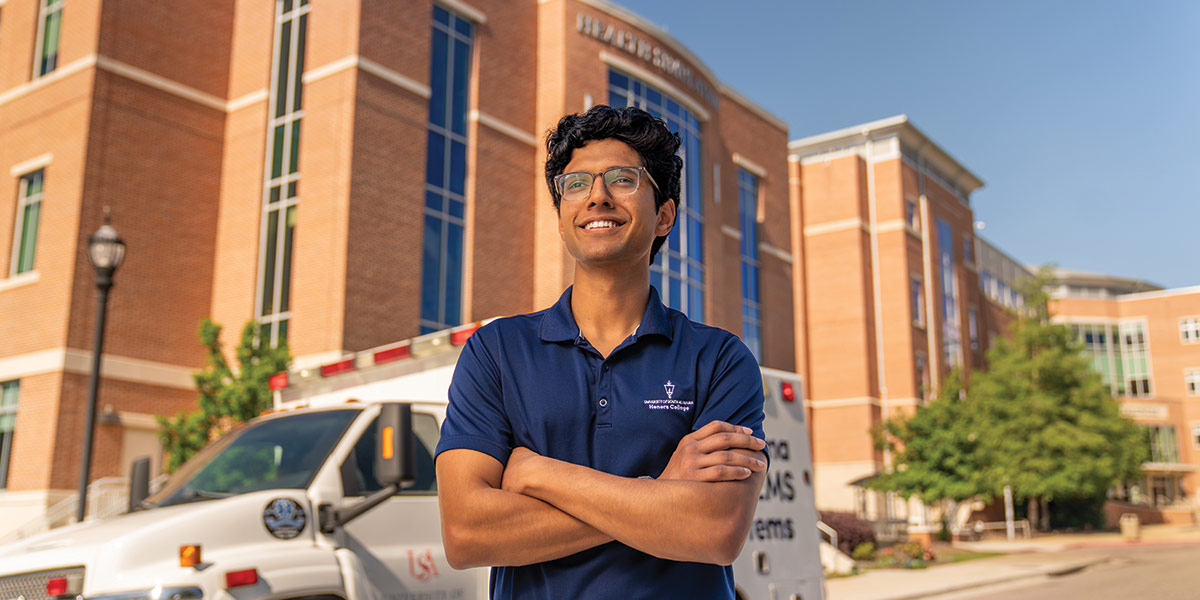 Suhas Patil standing in front of Allied Health building.