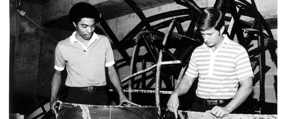 DR. BILL WILLIAMS, right, and student Alfred Archer saw potential for the Waterman Globe to find a home on the University of South Alabama campus. It was moved from storage at the Mobile Municipal Auditorium, pictured here, to the University, where it was eventually restored. 
