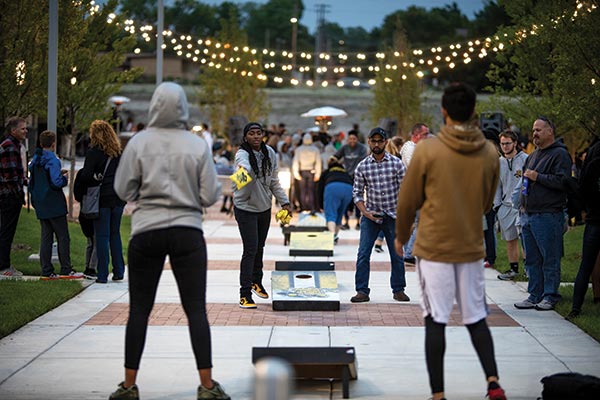 Students playing corn hole on campus.